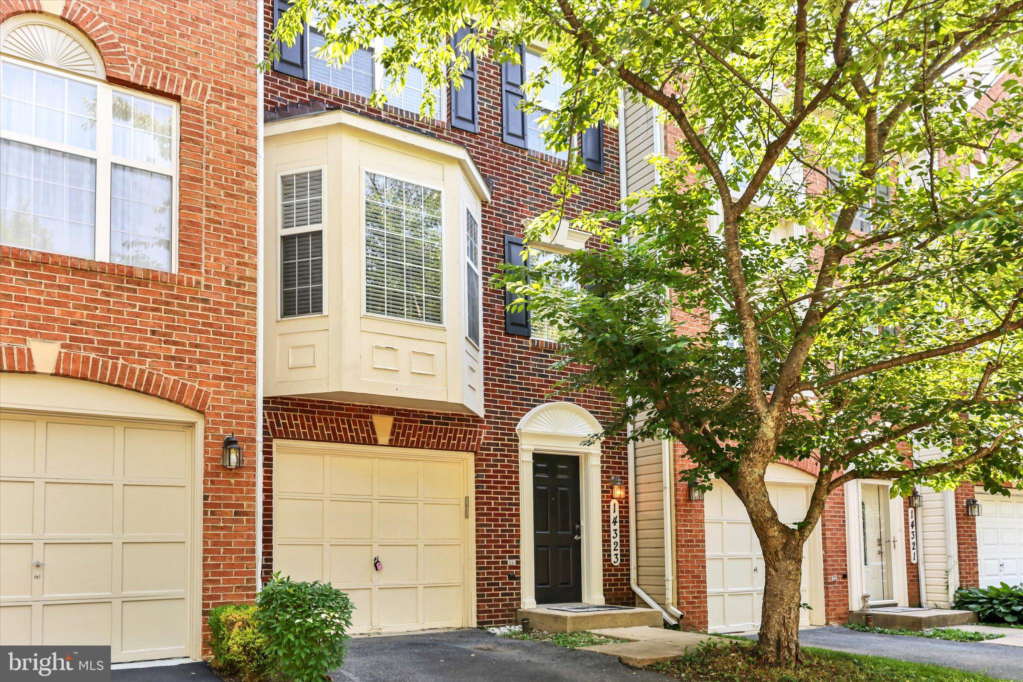 14323 Gate Dancer Lane Boyds, MD 20841 - Photo 1 of 54 Charming brick facade with lush greenery.
