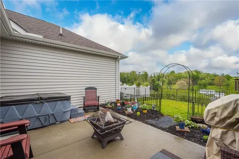 a view of a patio with a table chairs and a backyard
