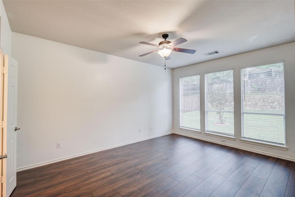 7048 Summit Parc Drive Dallas, TX 75249 - Photo 15 of 20 a view of an empty room with wooden floor and a window
