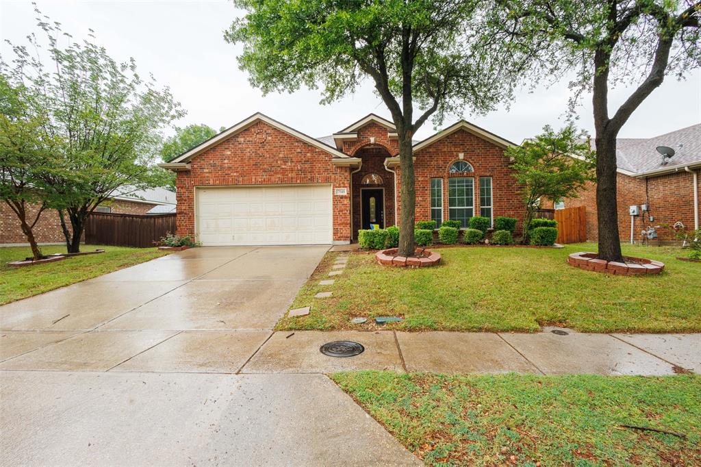 7048 Summit Parc Drive Dallas, TX 75249 - Photo 2 of 20 a front view of a house with garden