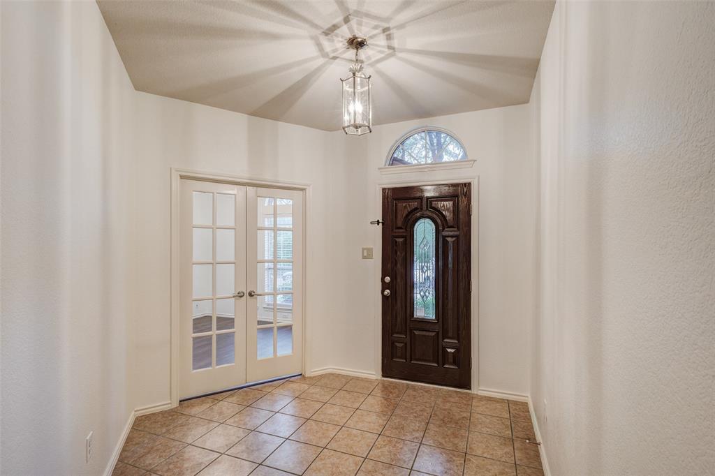 7048 Summit Parc Drive Dallas, TX 75249 - Photo 3 of 20 a view of a hallway with a chandelier fan and windows