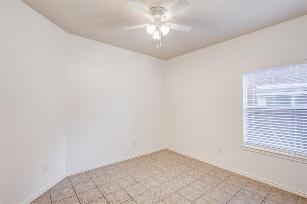 7048 Summit Parc Drive Dallas, TX 75249 - Photo 6 of 20 an empty room with a window and a fan