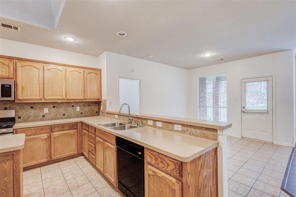 7048 Summit Parc Drive Dallas, TX 75249 - Photo 9 of 20 a kitchen with a sink stove and cabinets