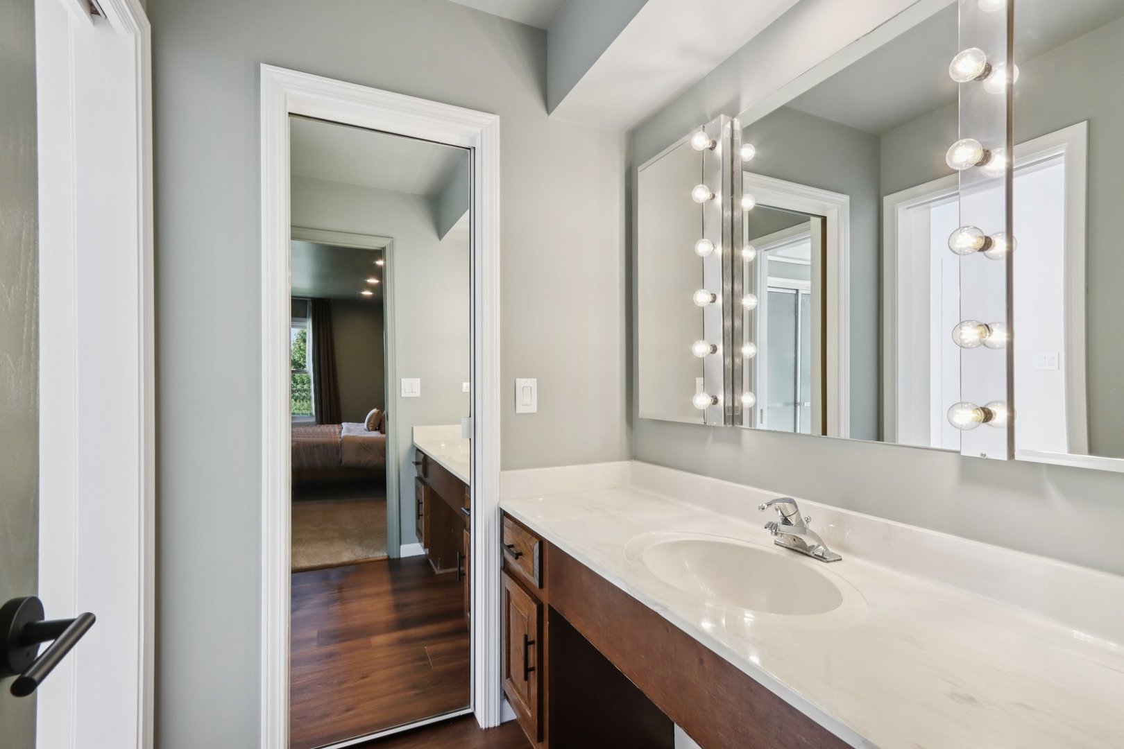 6527 Maple Street Morton Grove, IL 60053 - Photo 20 of 35 a en suite bathroom with a granite countertop sink mirror and vanity