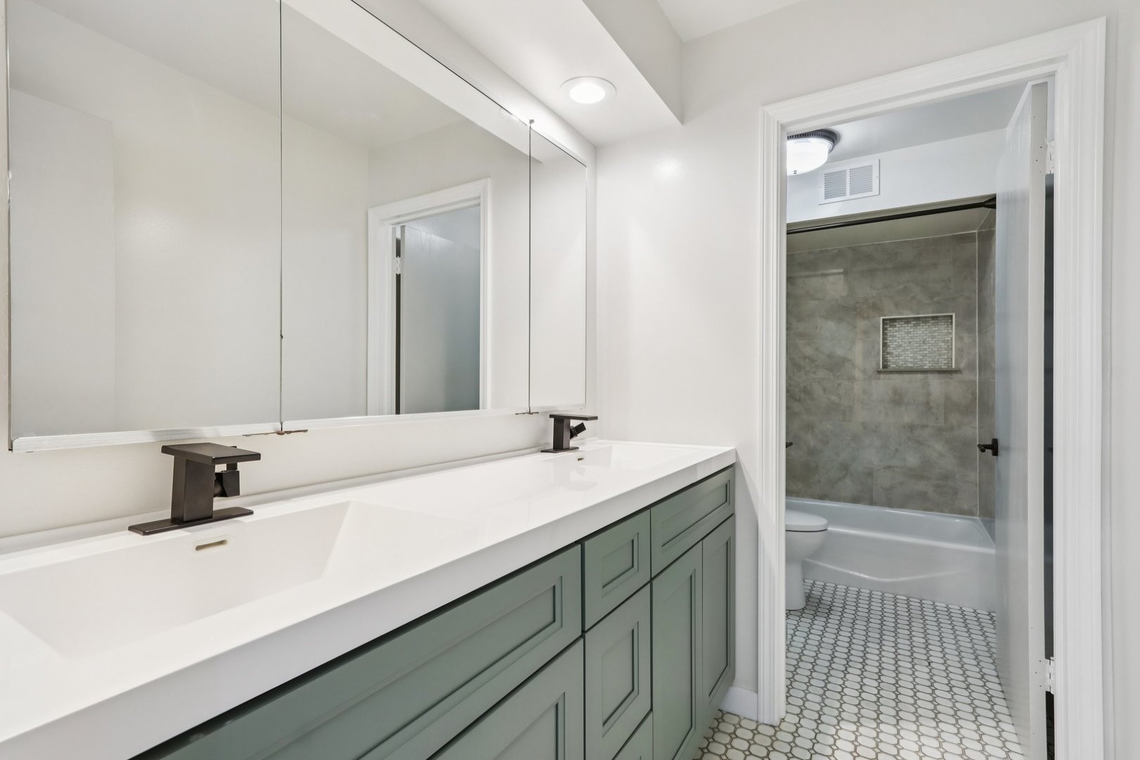 6527 Maple Street Morton Grove, IL 60053 - Photo 24 of 35 a bathroom with a sink and a mirror