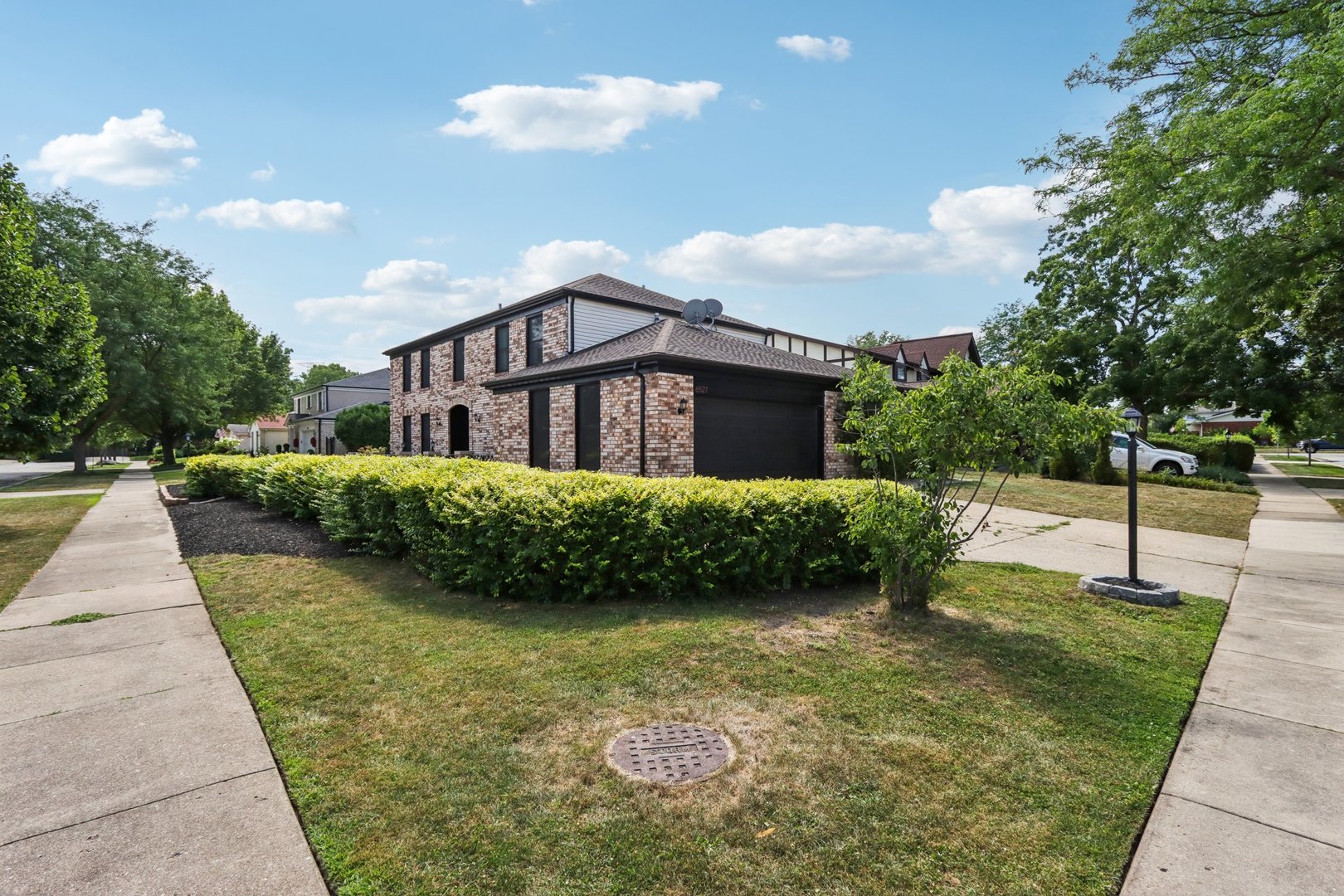 6527 Maple Street Morton Grove, IL 60053 - Photo 29 of 35 a front view of a house with garden