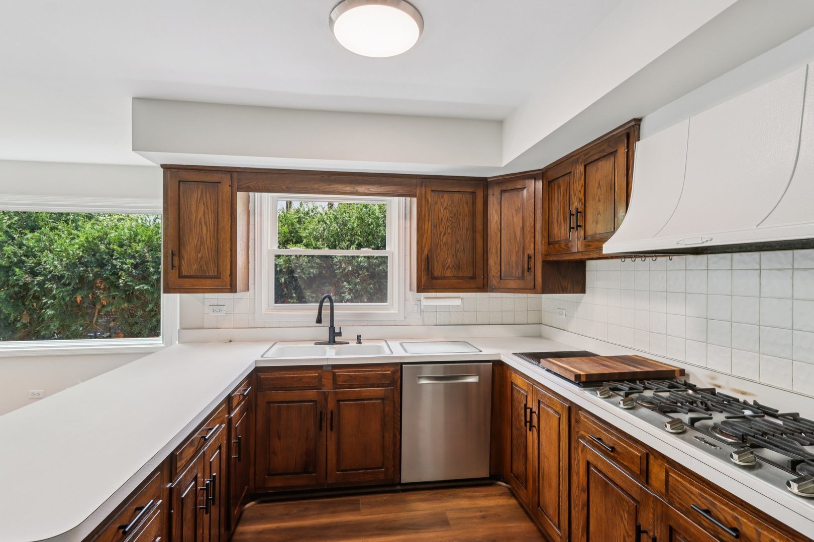 6527 Maple Street Morton Grove, IL 60053 - Photo 10 of 35 a kitchen with a sink stove top oven and cabinets