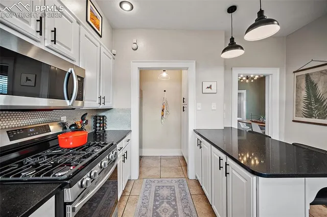 a kitchen with stainless steel appliances granite countertop a stove and a sink