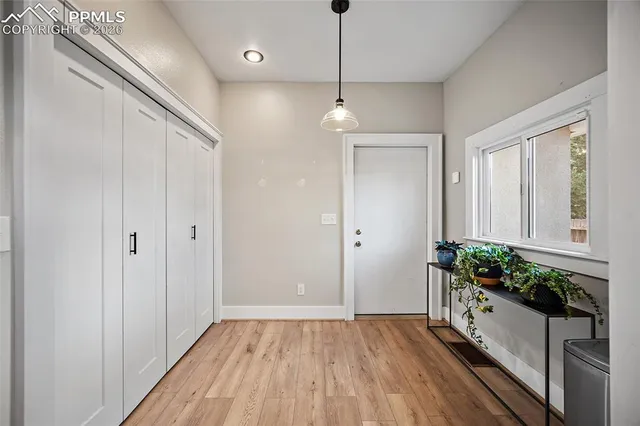 a view of an entryway with wooden floor