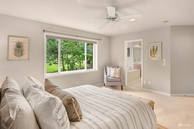a bedroom with a large bed and a window