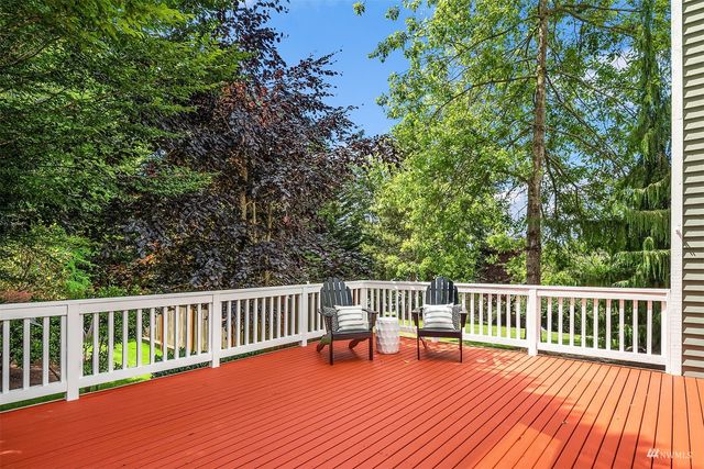 a balcony with wooden floor and fence