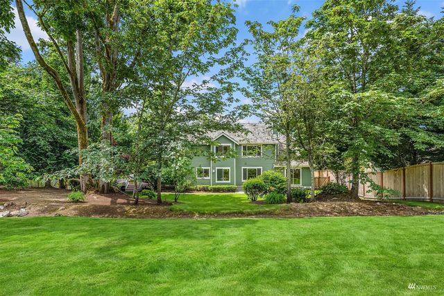 a view of a house with a backyard