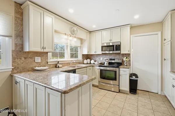 a kitchen with a sink cabinets and window