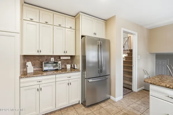 a kitchen with stainless steel appliances granite countertop a refrigerator and a sink