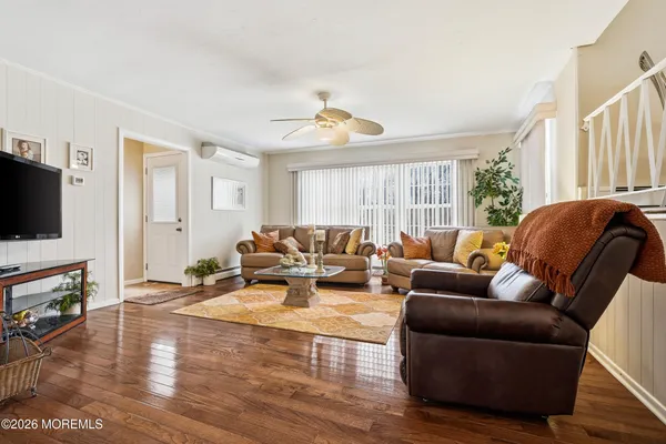 a living room with furniture fireplace and flat screen tv