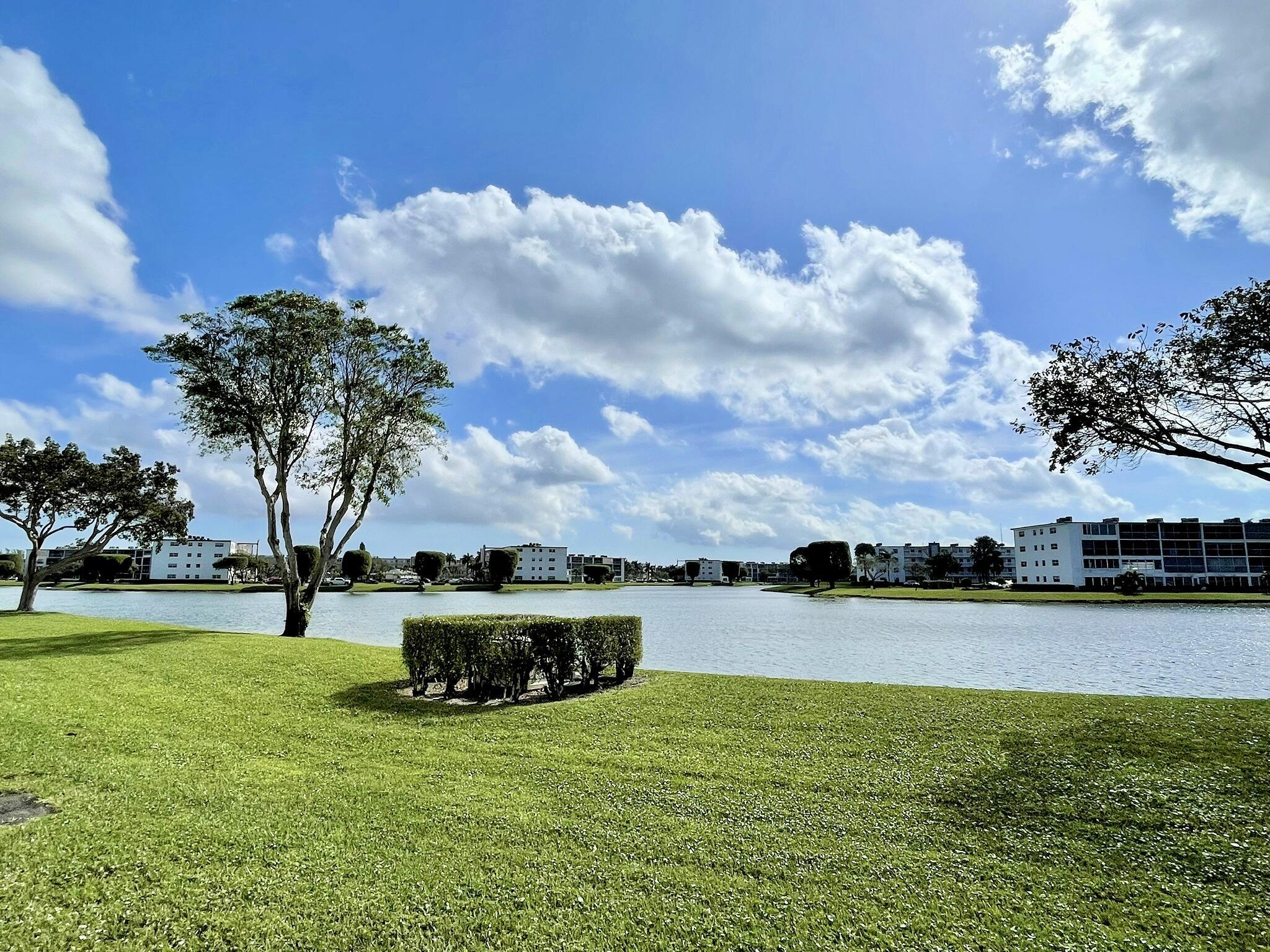 1030 Rexford B Boca Raton, FL 33434 - Photo 25 of 27 a view of a lake with a big yard and potted plants