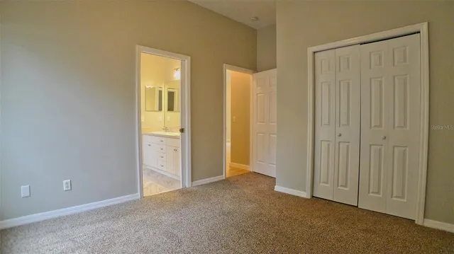 a view of an empty room with closet area