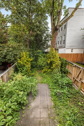 a view of a kitchen with windows and refrigerator