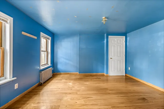 a kitchen with stainless steel appliances granite countertop a refrigerator oven a sink dishwasher and white cabinets with wooden floor