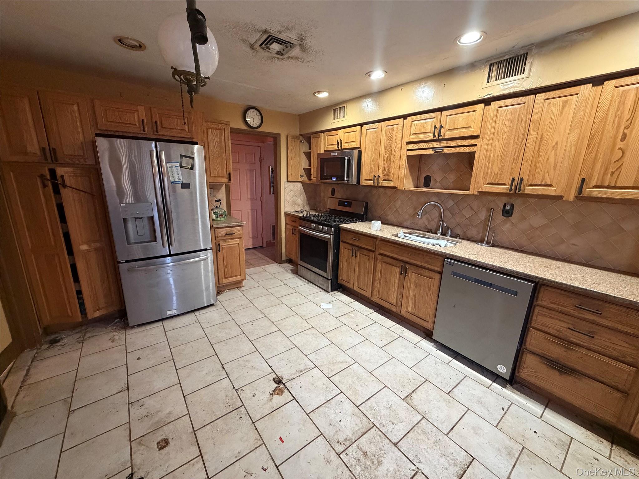 15 Bonnie Court Spring Valley, NY 10977 - Photo 12 of 22 a kitchen with stainless steel appliances granite countertop a refrigerator and a sink