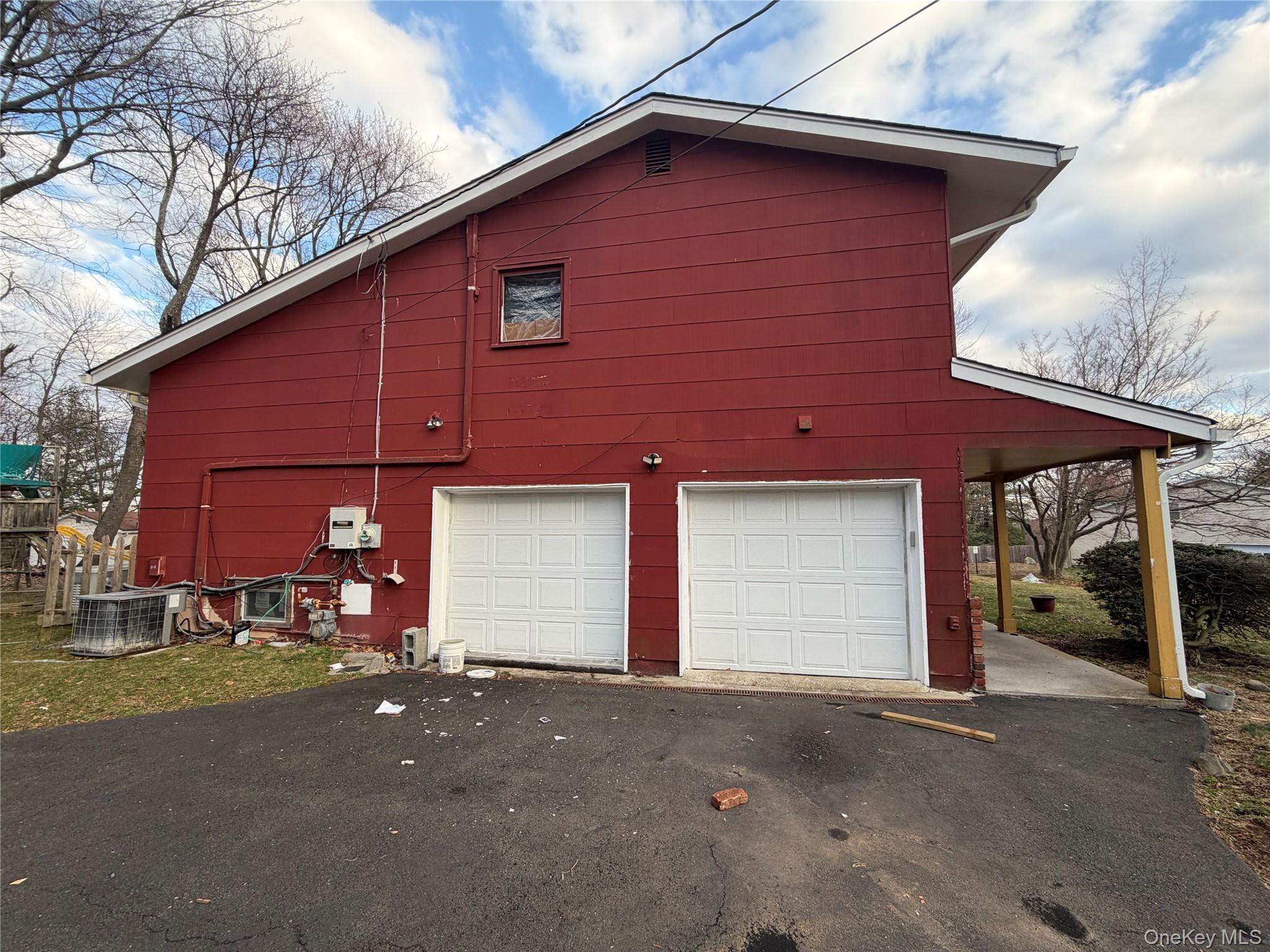 15 Bonnie Court Spring Valley, NY 10977 - Photo 16 of 22 a front view of a house with a yard and garage