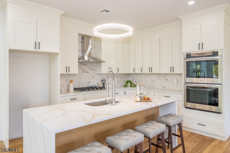 124 Wheatsworth Road Hamburg, NJ 07419 - Photo 15 of 50 a kitchen with a white cabinets and chairs