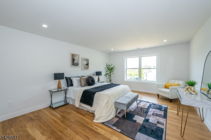 124 Wheatsworth Road Hamburg, NJ 07419 - Photo 43 of 50 a spacious bedroom with a bed a couch and a window