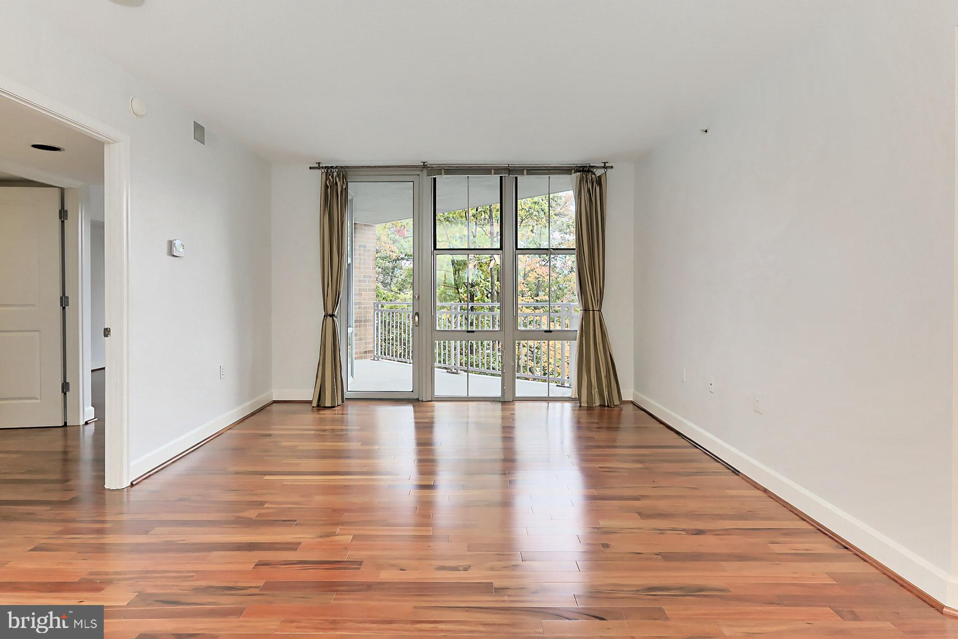 11800 Sunset Hills Road, Unit 513 Reston, VA 20190 - Photo 8 of 43 Open concept living with floor to ceiling windows