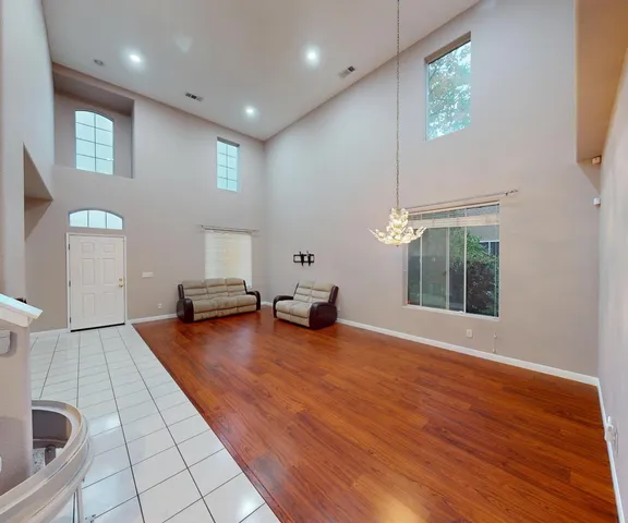 a view of a livingroom with furniture and floor to ceiling window