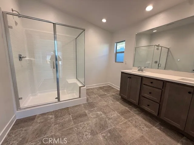 a bathroom with a shower sink and mirror