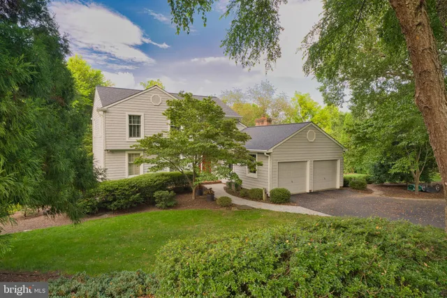 a view of a house with yard and a garden
