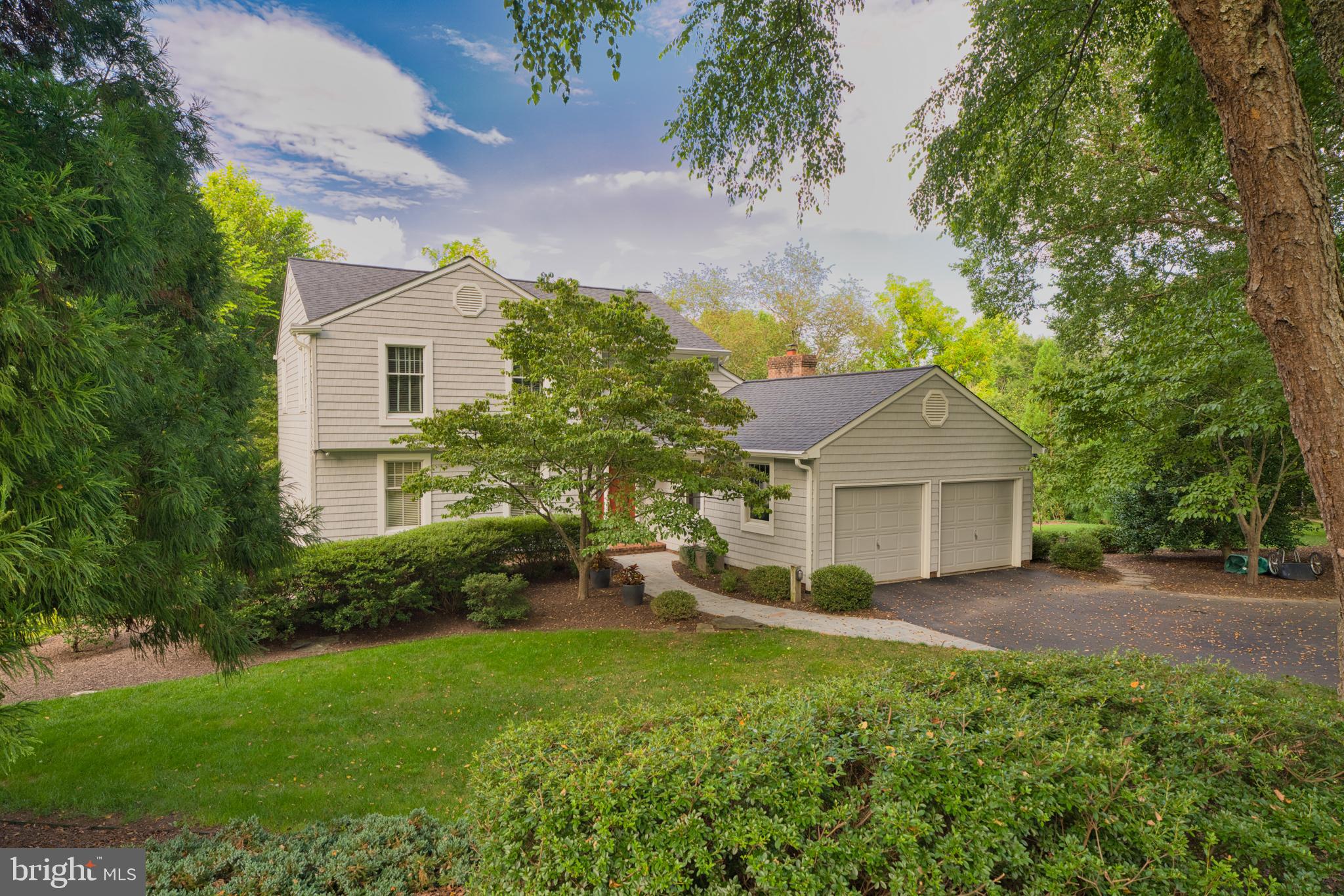 a view of a house with yard and a garden