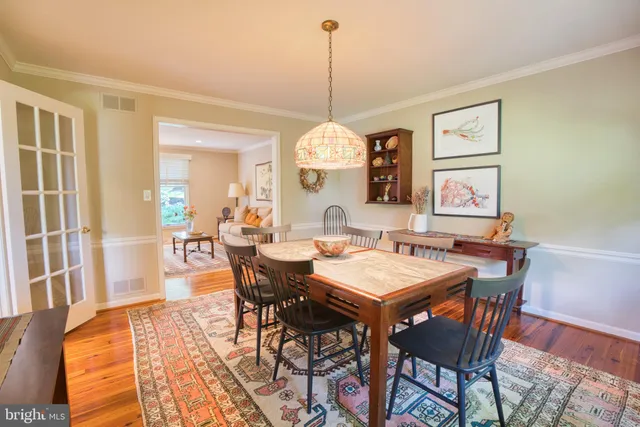 a kitchen with stainless steel appliances granite countertop table chairs refrigerator and microwave