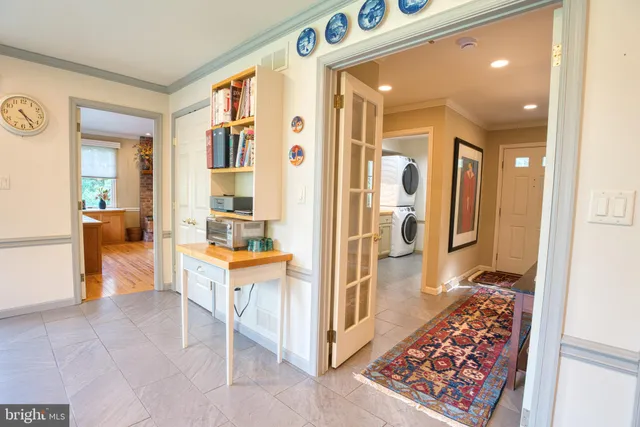 a living room with a bed and furniture with wooden floor