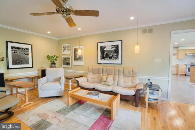 a spacious bedroom with a bed and ceiling fan