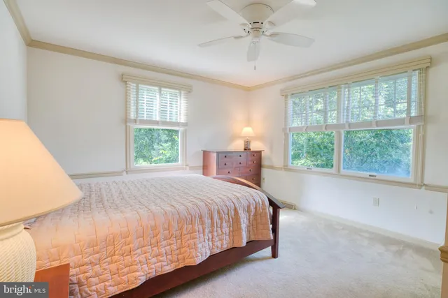 a living room with stainless steel appliances furniture and flat screen tv