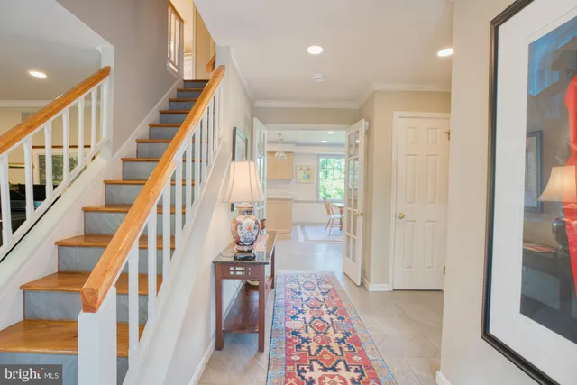 a view of an entryway with wooden floor and a livingroom view