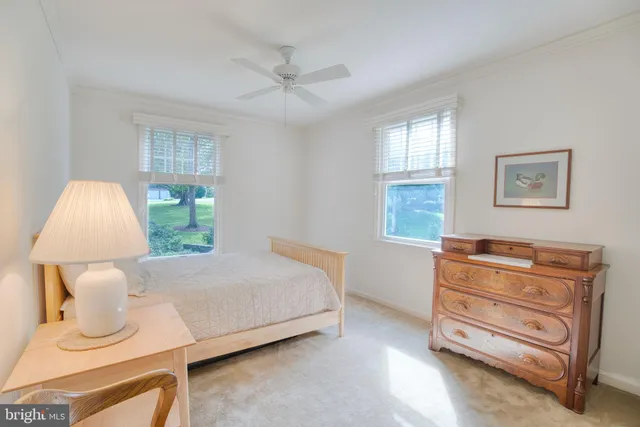 a living room with furniture a flat screen tv and a table