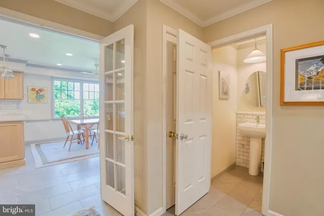 a view of a hallway to a livingroom with wooden floor and a rug