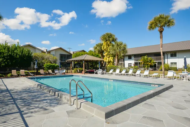 a swimming pool with outdoor seating yard and barbeque oven