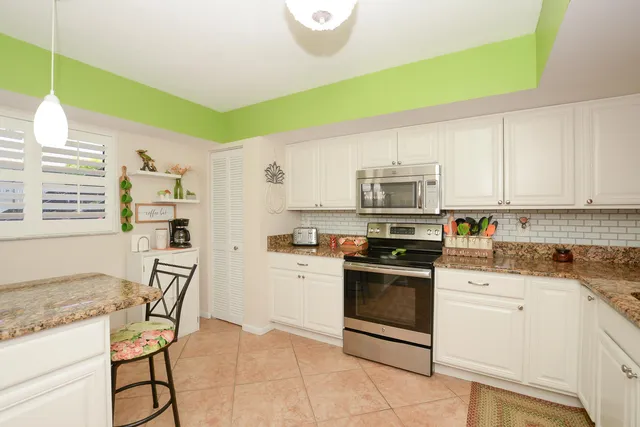 a kitchen with stainless steel appliances granite countertop a stove and a refrigerator