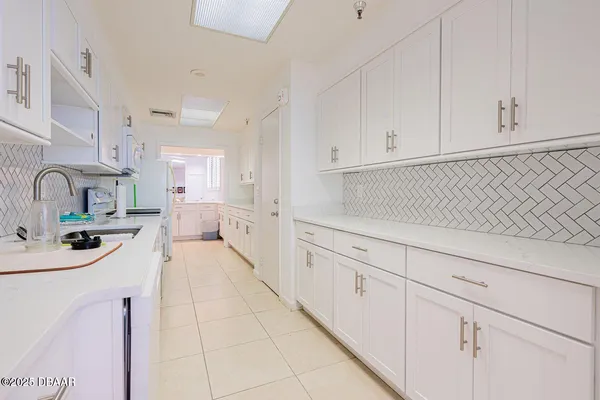 a living room with furniture and a book shelf