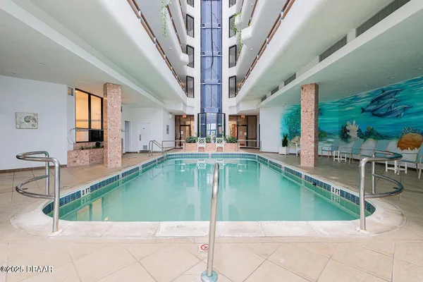 a view of a living room and kitchen with a large tub
