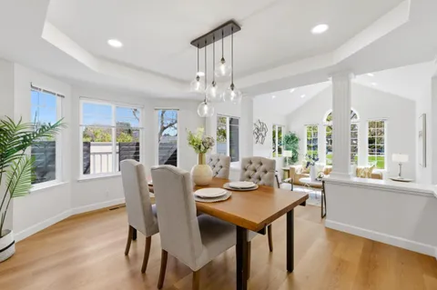 a view of a dining room with furniture window and wooden floor