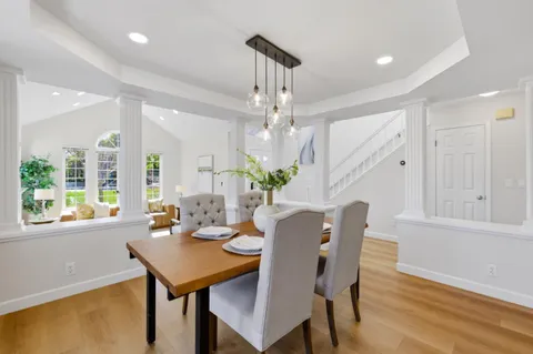 a view of a dining room with furniture window and wooden floor