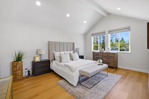 a bedroom with a bed and a desk