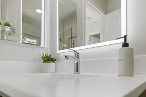 a view of patio with table and chairs potted plants and a palm tree