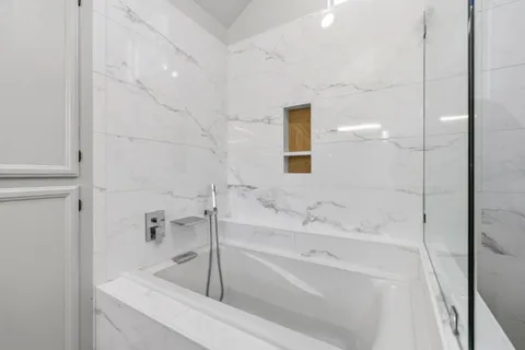 a view of a backyard with potted plants and large trees