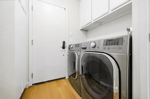 a bedroom with a bed a mirror and a table