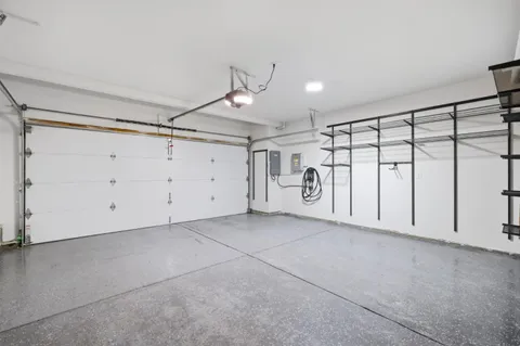 a view of a park that has a sign board large trees